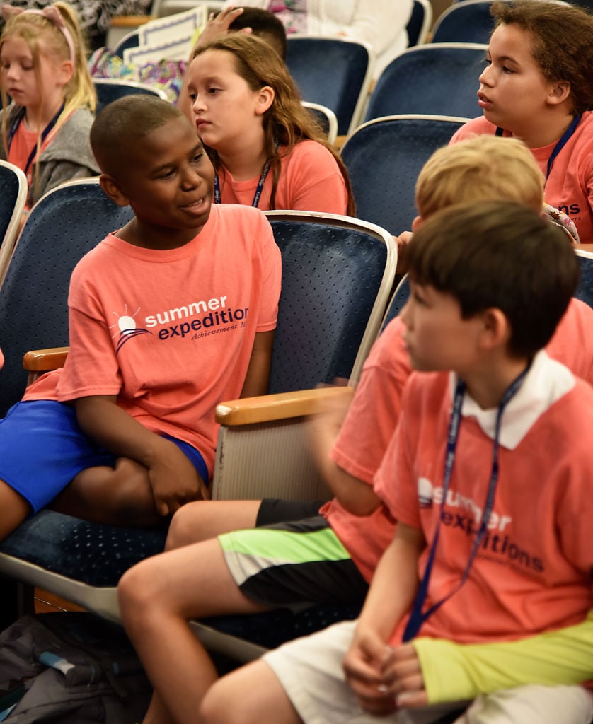 N'axavier Holland talks with fellow students Ransom Mack and Kai Dungan during the Summer Expeditions Celebration